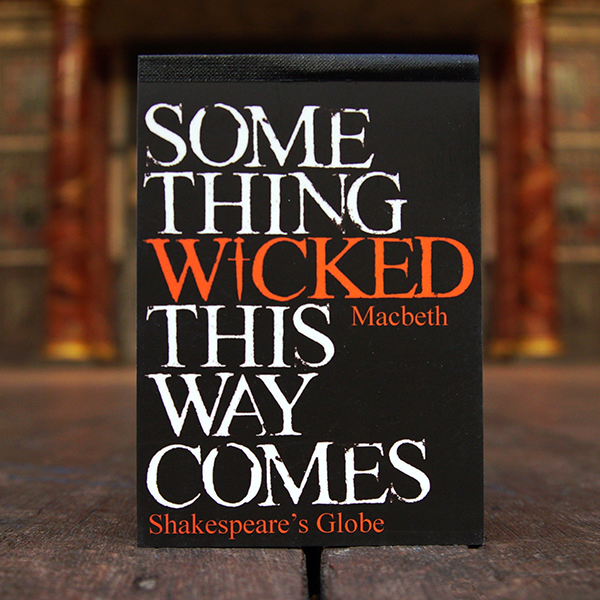 Black pocket sized notepad with a quote from Shakespeare play, Macbeth printed in white on orange on the cover. The lettering is slightly destroyed and the 'i' of wicked is replaced with a dagger.