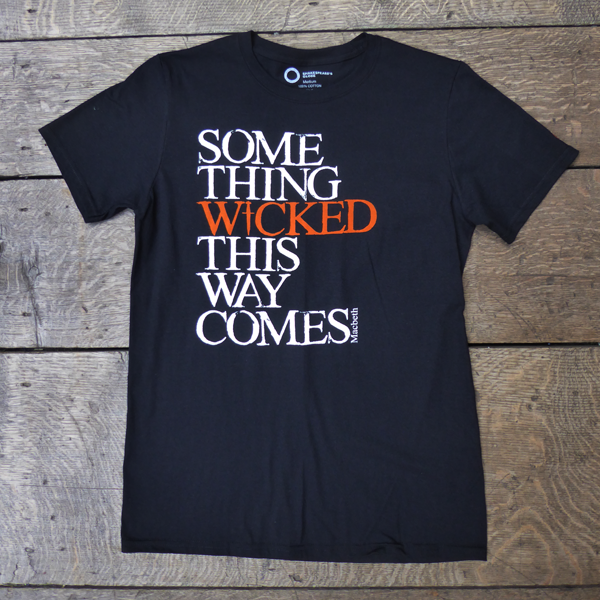 Black cotton crew neck, short sleeve t-shirt with a quote from Shakespeare play, Macbeth printed on the chest. The quote is printed in white, slightly distressed capital letters with the word 'wicked' printed in bright orange. 