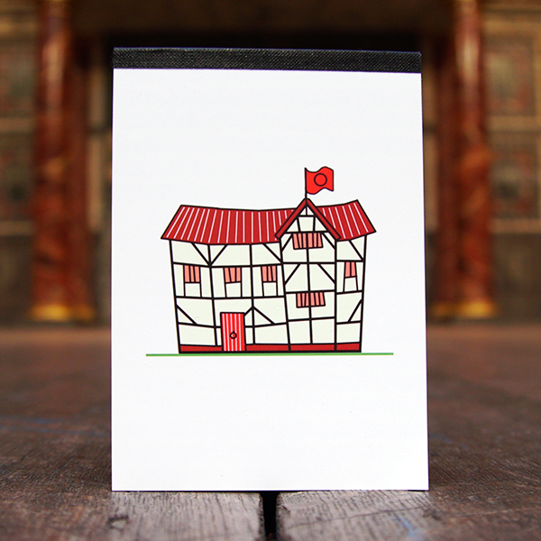 White pocket sized notepad with a print of a cartoon version of Shakespeare's Globe Theatre on the cover. The little Globe Theatre has a dark red roof and a red flag and door.