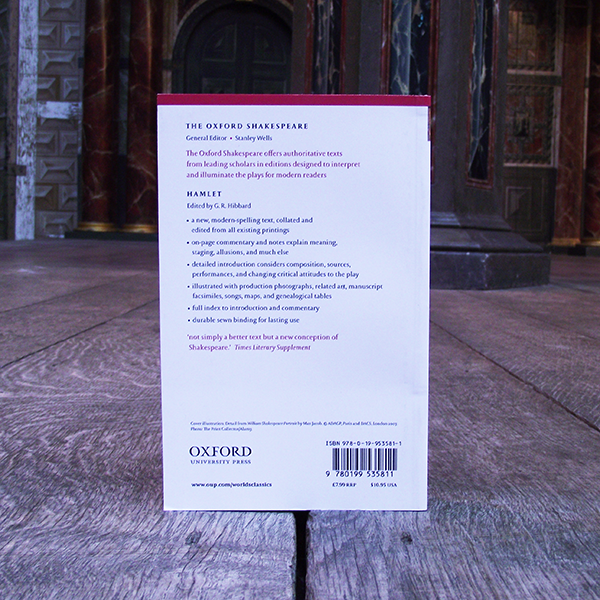 Back cover of a paperback book on a wooden surface