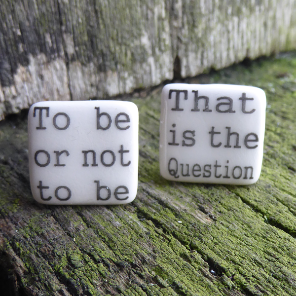 
                  
                    Square ceramic cufflinks made of creamy white glazed earthenware. Each cufflink has part of a quote from Shakespeare play, Hamlet in black in a simple serif font. One cufflink says "To be or not to be" and the other "That is the Question"
                  
                