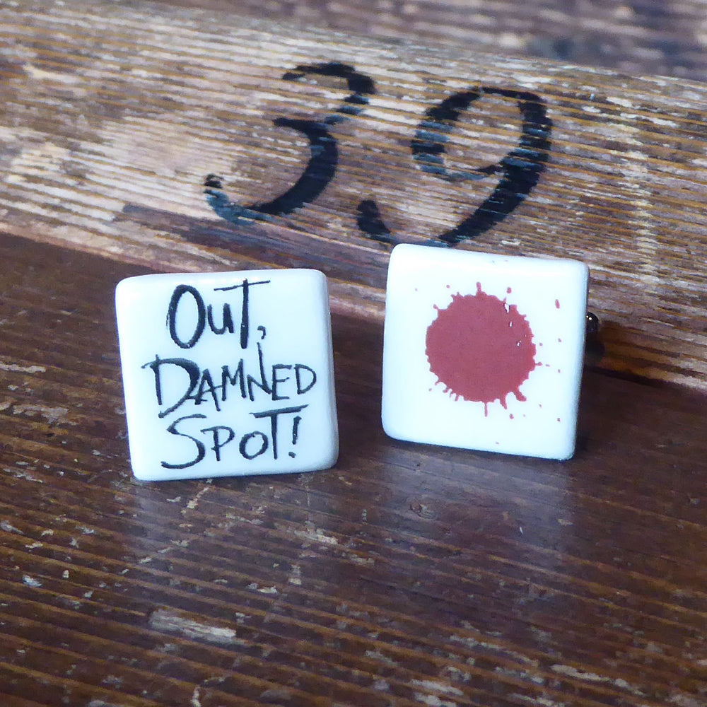 
                      
                        Ceramic cufflinks featuring a quote from Lady Macbeth on one (Out, damned spot!) and a blood spot on the other
                      
                    