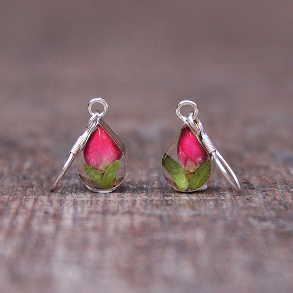 Teardrop earrings featuring tiny real rose buds encased in resin