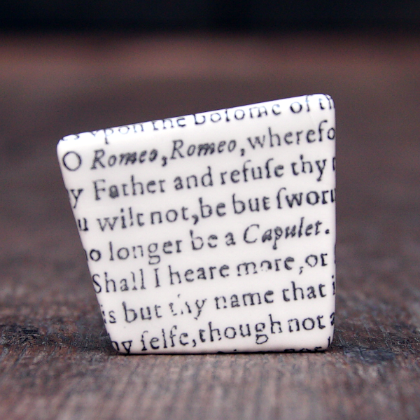 
                      
                        Asymmetric ceramic brooch with a snippet of Juliet's balcony speech from Shakespeare's Romeo and Juliet
                      
                    