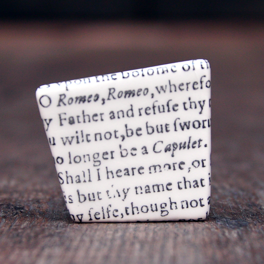 
                  
                    Asymmetric ceramic brooch with a snippet of Juliet's balcony speech from Shakespeare's Romeo and Juliet
                  
                