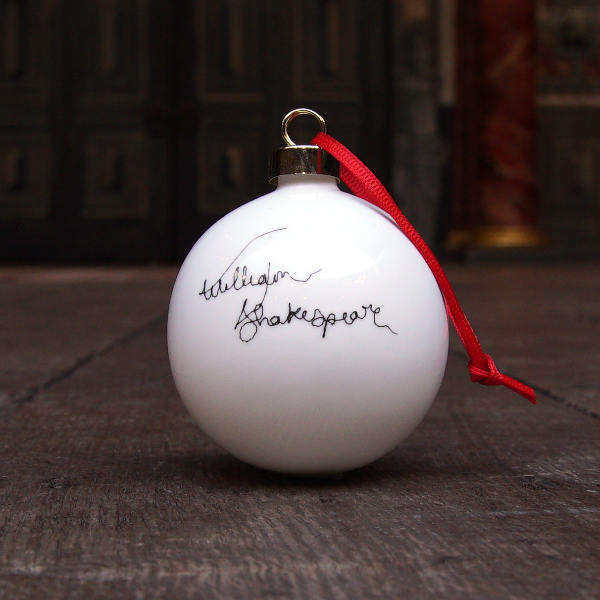 
                      
                        White fine china hanging bauble with a gold ferule and red ribbon. On the bauble is a portrait of William Shakespeare based on an embroidery. The portrait is made up of black lines and has a scribbled look.
                      
                    