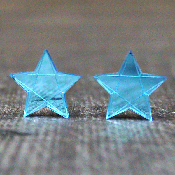 Star shaped stud earrings made from light blue mirrored acrylic. The stars are engraved to look faceted