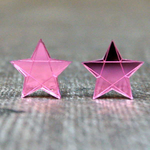 
                  
                    Star shaped stud earrings made from light pink mirrored acrylic. The stars are engraved to look faceted
                  
                