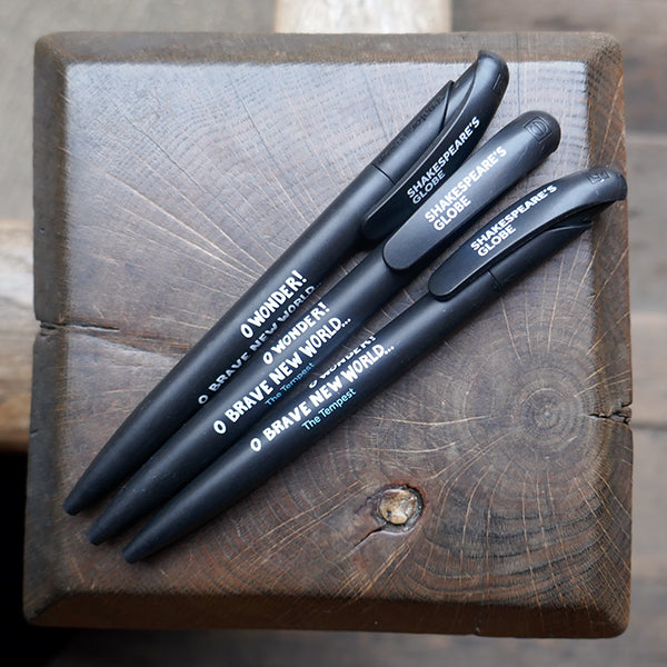 Black bioplastic ballpoint pen printed on the barrel with a quote from Shakespeare play, the Tempest, "O wonder! O brave new world..." in white hand-drawn lettering