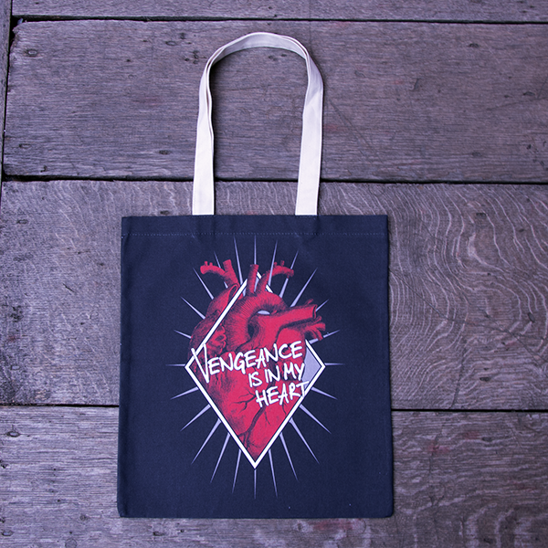 
                  
                    Black cotton bag with natural cotton handles, printed with an image celebrating Shakespeare play, Titus Andronicus. A red anatomical heart is partly enclosed by a white diamond frame. Gold rays emanate from behind the frame. Across the front of the image is a quote from the play (vengeance is in my heart) in white lettering.
                  
                
