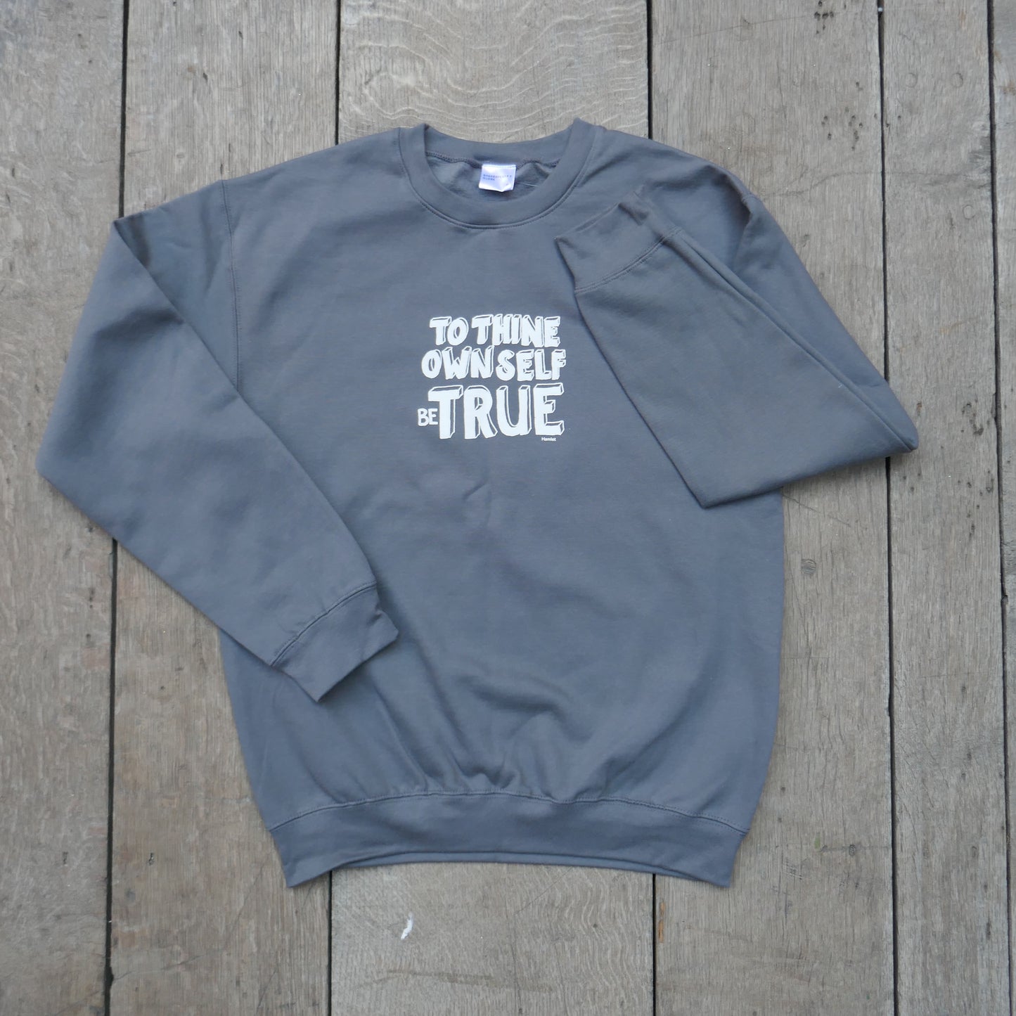 
                  
                    Grey cotton blend sweatshirt with white graphic text in centre front.
                  
                