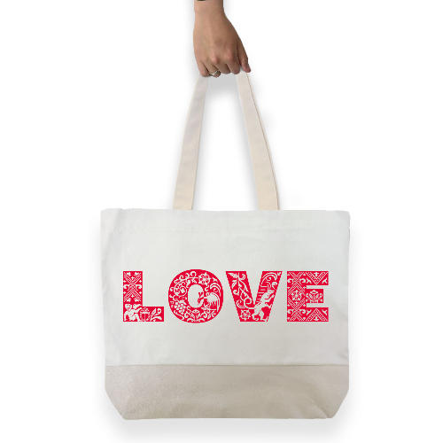 White cotton tote bag with beige handles and base, featuring large red graphic text saying LOVE across front