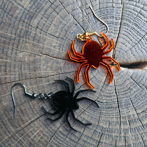 Perspex acrylic drop earring shaped like spiders.  The spiders are made from mirror acrylic in either black or orange.